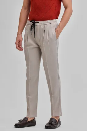 Beige Textured Relaxed Fit Trousers